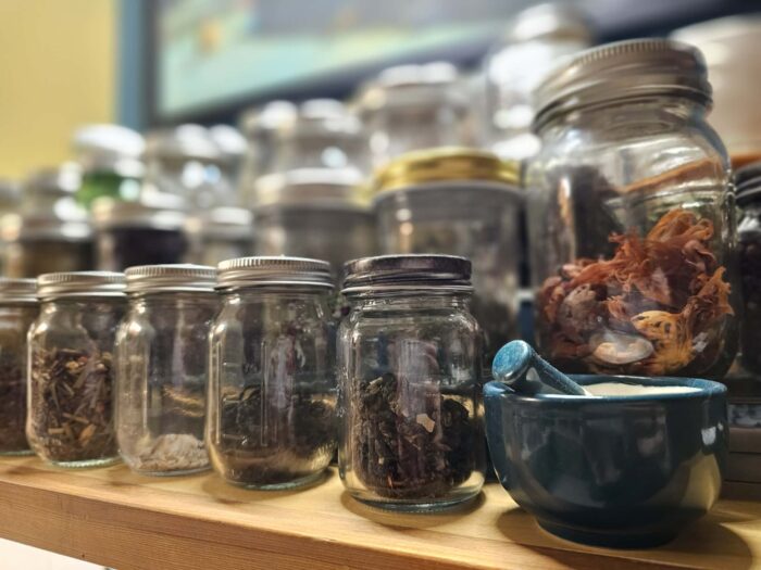 mortar and pestle with jars of herbs in a tea nook